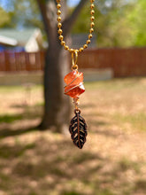 Load image into Gallery viewer, Crystal Swirl &amp; Feather Guardian – Tangerine Aura Quartz Necklace | Wire Wrapped Pendant for Joy &amp; Creative Energy
