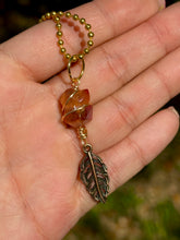 Load image into Gallery viewer, Crystal Swirl &amp; Feather Guardian – Tangerine Aura Quartz Necklace | Wire Wrapped Pendant for Joy &amp; Creative Energy
